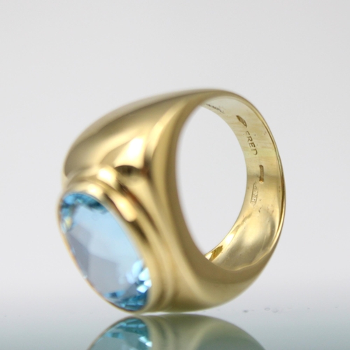 163 - A 'Fred' Paris 18ct yellow gold untested blue topaz dress ring, the oval mixed cut blue stone within... 