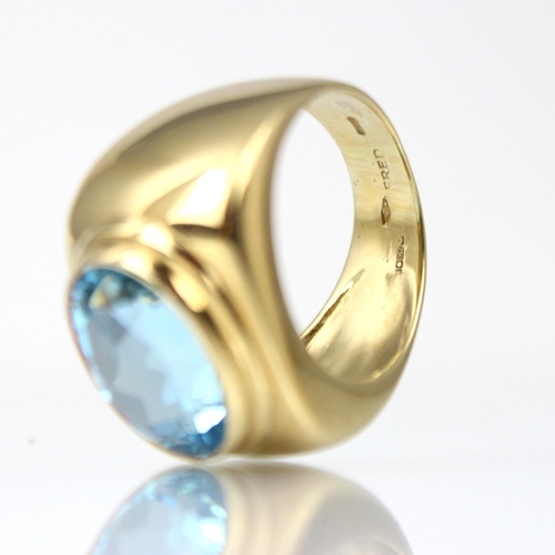 163 - A 'Fred' Paris 18ct yellow gold untested blue topaz dress ring, the oval mixed cut blue stone within... 