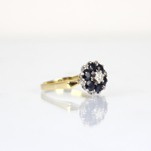 170 - An Edwardian style sapphire and diamond cluster ring, the central round cut diamond within surround ... 