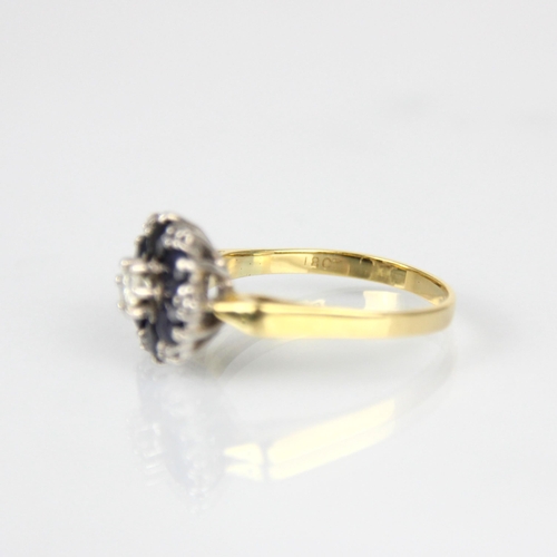 170 - An Edwardian style sapphire and diamond cluster ring, the central round cut diamond within surround ... 