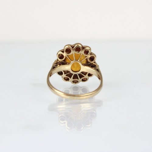 176 - An early 20th century citrine and pearl cluster ring, the central oval cut citrine within surround o... 