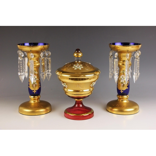 524 - A pair of Bohemian style blue glass and gilt table lustres, 20th century, the baluster stems applied... 