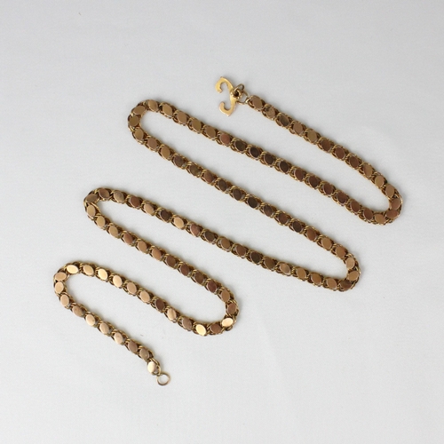 361 - A yellow metal chain, the oval discs applied to curb link chain, with double ended clasp, indistinct... 