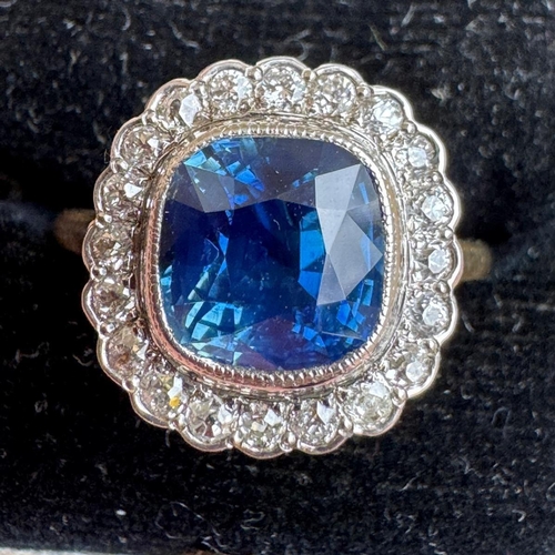 363 - An early/mid 20th century certified sapphire and diamond cluster ring, the mixed cut sapphire within... 