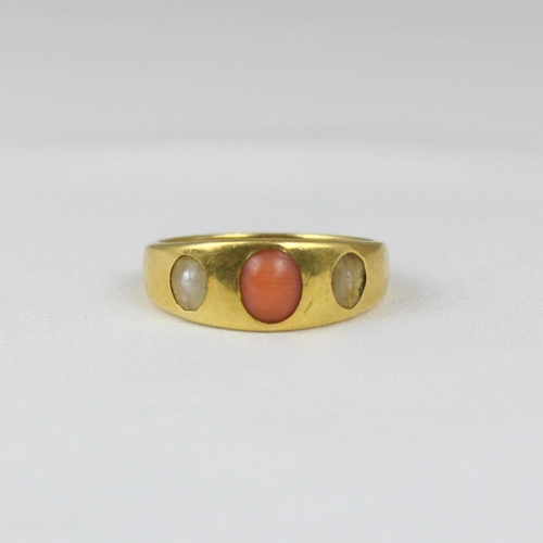 364 - An early 20th century coral and 'pearl' ring, the gypsy set cabochon coral with 'pearl' to each side... 