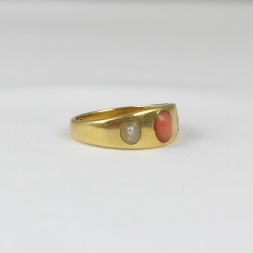 364 - An early 20th century coral and 'pearl' ring, the gypsy set cabochon coral with 'pearl' to each side... 