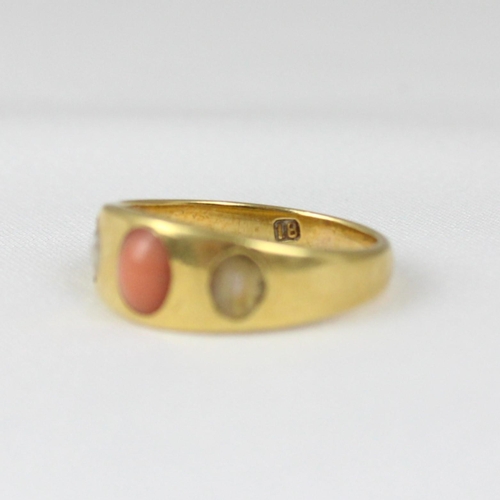 364 - An early 20th century coral and 'pearl' ring, the gypsy set cabochon coral with 'pearl' to each side... 