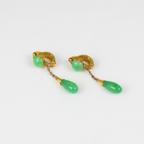 374 - A pair of yellow metal 'jade' drop earrings, the circular cabochon suspending trace link chain and t... 