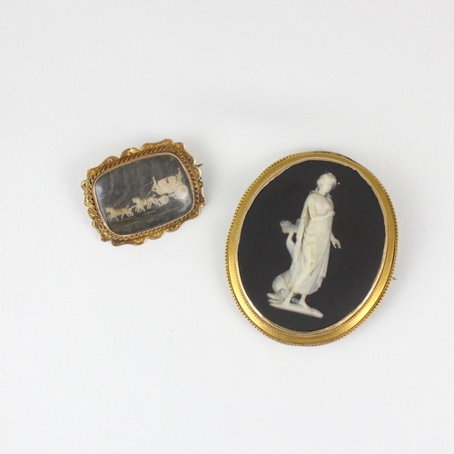 376 - A late 19th century yellow metal cameo, the rectangular panel depicting carriage scene, within shape... 