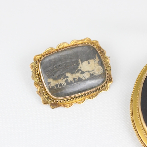 376 - A late 19th century yellow metal cameo, the rectangular panel depicting carriage scene, within shape... 