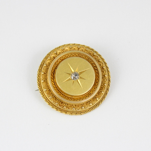 377 - A late 19th century yellow metal diamond brooch, the old cut diamond within unmarked circular yellow... 