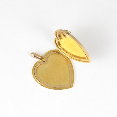 383 - An early 20th century yellow metal heart pendant/locket, the plain polished front with applied fly, ... 