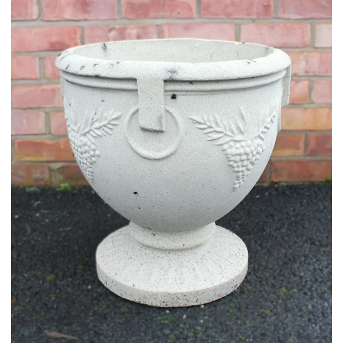 1009 - A composite garden urn, of ovoid form, moulded in relief with hanging fruit, upon an integral spread... 