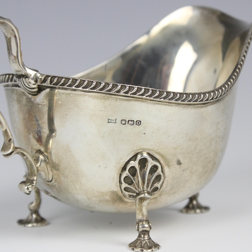 79 - A George VI silver sauce boat, Walker and Hall, Sheffield 1946, the gadrooned rim above plain polish... 