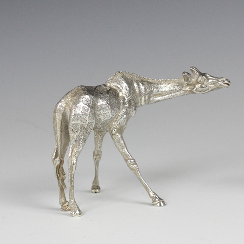 81 - A near pair of Patrick Mavros silver models of giraffes, each modelled standing with realistically c... 