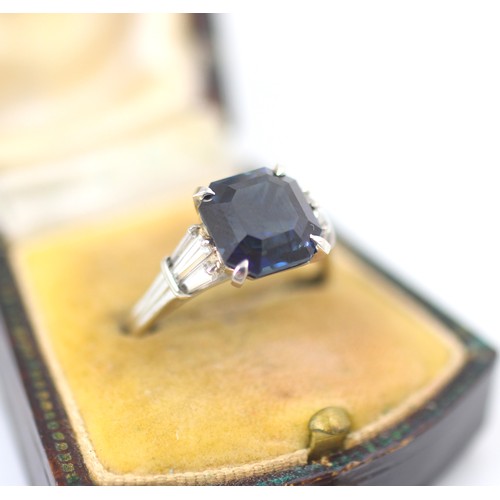 177 - An Art Deco style diamond and untested sapphire ring, the central emerald cut untested sapphire claw... 