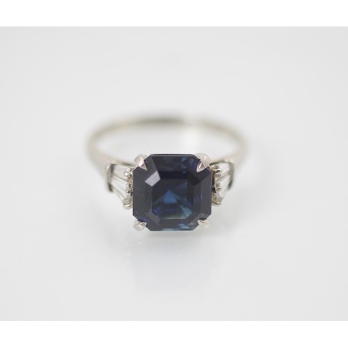177 - An Art Deco style diamond and untested sapphire ring, the central emerald cut untested sapphire claw... 