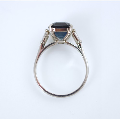 177 - An Art Deco style diamond and untested sapphire ring, the central emerald cut untested sapphire claw... 