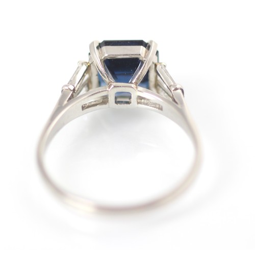 177 - An Art Deco style diamond and untested sapphire ring, the central emerald cut untested sapphire claw... 