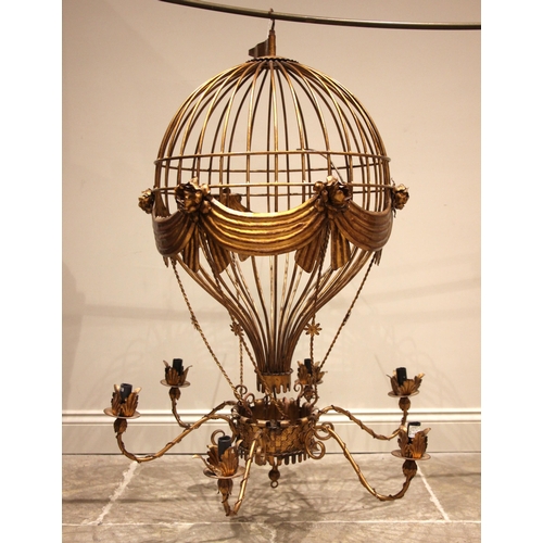 777 - A 20th century gilt metal hanging ceiling light, modelled as a hot air balloon, over six scrolled 'S... 