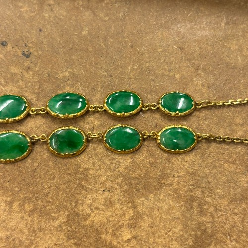 371 - A Chinese yellow metal 'jade' necklace, composed of ten graduated oval panels, suspending further ov... 