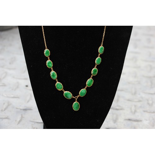 371 - A Chinese yellow metal 'jade' necklace, composed of ten graduated oval panels, suspending further ov... 