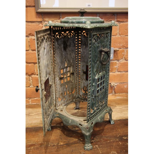 770 - A late 19th century green enamelled cast iron cathedral heater cabinet, of openwork foliate design, ... 