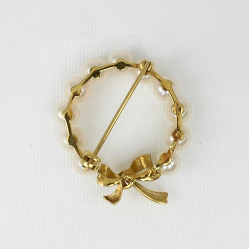 182 - A yellow metal cultured pearl brooch, possibly by Mikimoto, the eleven uniform cultured pearls set i... 