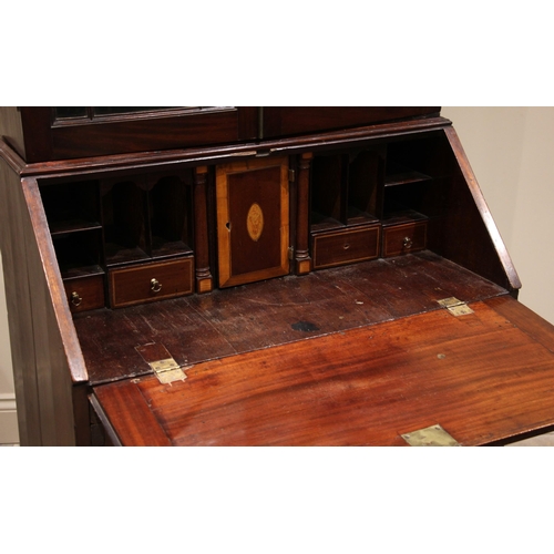 895 - A George III mahogany bureau bookcase, the moulded cornice above a pair of astragal glazed doors, up... 