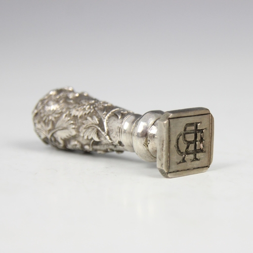 72 - A late 19th century Chinese white metal desk seal, possibly Canton, the tapered embossed handle deco... 