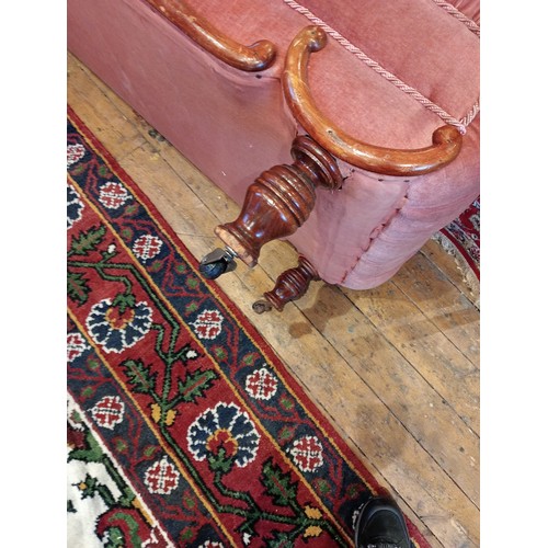 911 - A Victorian day bed, in pink mohair button down fabric, the scroll end extending to a straight front... 