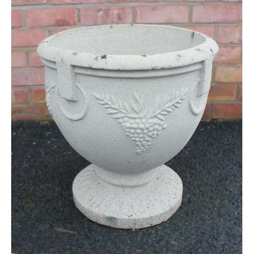 1009 - A composite garden urn, of ovoid form, moulded in relief with hanging fruit, upon an integral spread... 