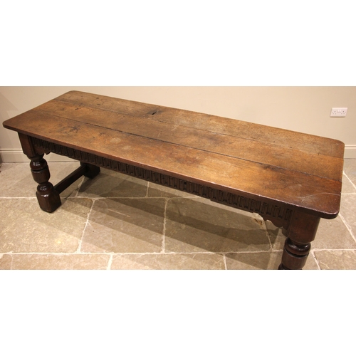 863 - A 17th century style oak refectory/serving table, the three plank top over a nulled frieze to two si... 