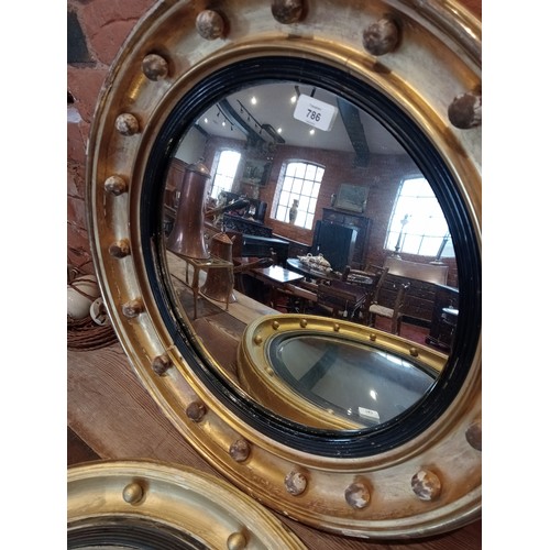 786 - A 19th century giltwood and gesso circular wall mirror, the moulded frame applied with spheres, encl... 