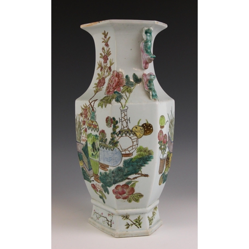 685 - A Chinese famille vert vase, of hexagonal baluster form and externally decorated with vases and flow... 