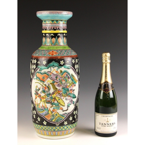 692 - A large pair of Chinese porcelain famille noire rouleau vases, each decorated with two shaped vignet... 