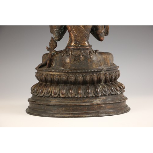 702 - A South East Asian gilt bronze Bodhisattva, seated in dhyanasana on a double lotus base and both han... 