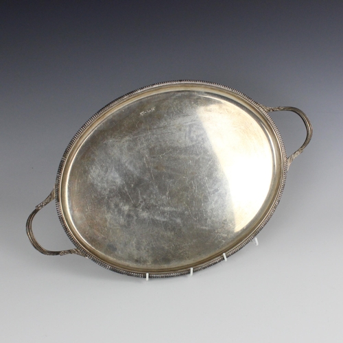 109 - A late 20th century silver tray, ‘DIS’ Sheffield 1973, of oval form with gadroon style rim and twin ... 