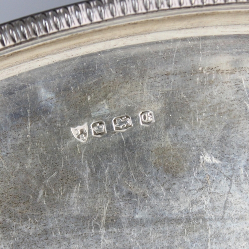 109 - A late 20th century silver tray, ‘DIS’ Sheffield 1973, of oval form with gadroon style rim and twin ... 