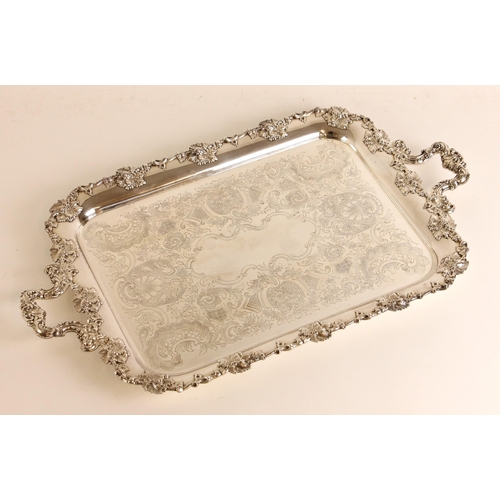 127 - An early 20th century silver plated tray, the foliate cast rectangular rim above florally engraved w... 