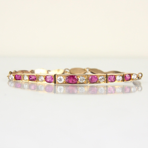 217 - A 20th century untested ruby and white sapphire bracelet, the seven mixed cut untested rubies within... 