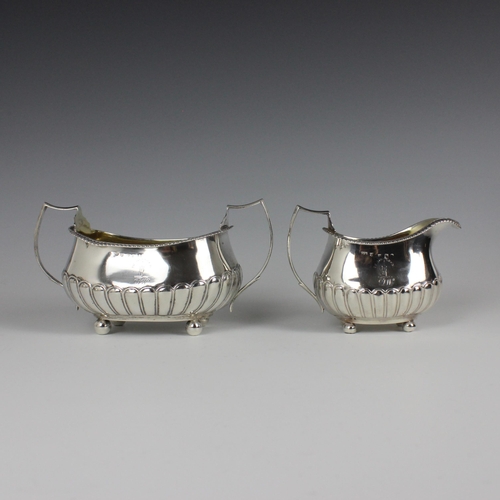 101 - A George III silver milk jug and sugar bowl, Francis Howden, Edinburgh 1811, the gadrooned rim above... 