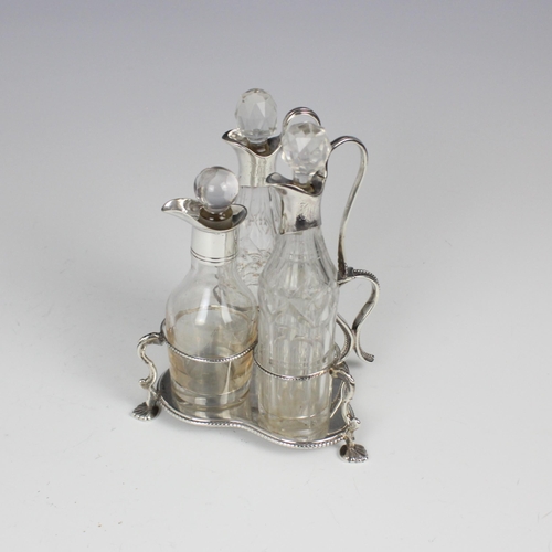 104 - A Victorian silver cruet stand, Henry Wilkinson and Co, Sheffield 1843, the stylised shamrock shaped... 