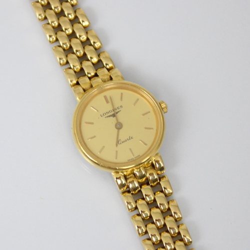 209 - A ladies yellow metal Longines quartz wristwatch, the circular gold coloured dial with baton markers... 