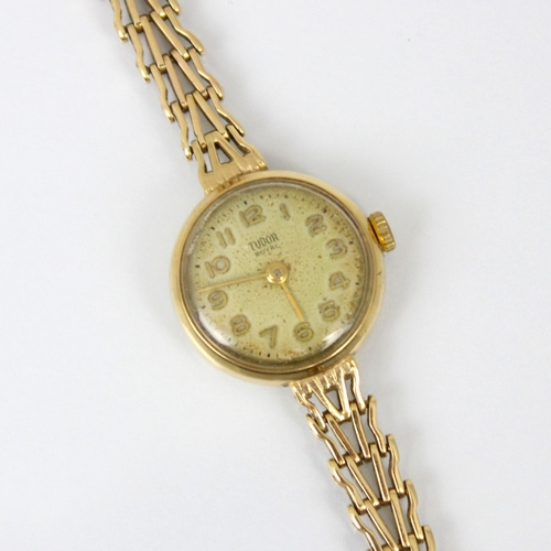 215 - A ladies yellow metal Tudor Royal wristwatch, the circular cream coloured dial with Arabic numerals,... 