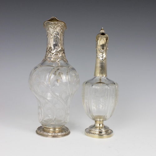 87 - A late 19th/early 20th century French white metal mounted claret jug, the domed hinged cover above C... 