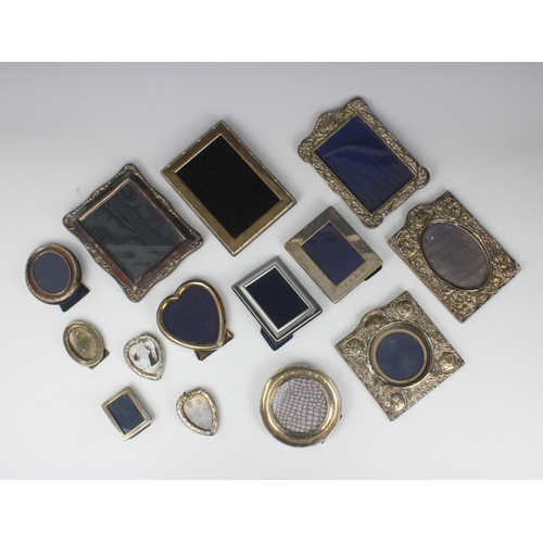 93 - A group of fourteen silver and white metal mounted photograph frames, including a continental heart ... 