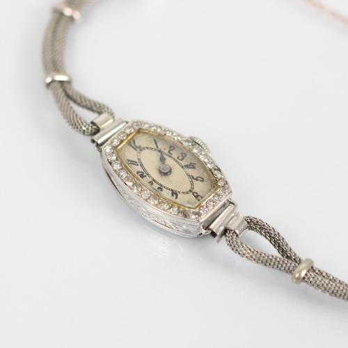 86 - An Art Deco ladies diamond cocktail wristwatch, the tonneau shaped dial with Arabic numerals, within... 