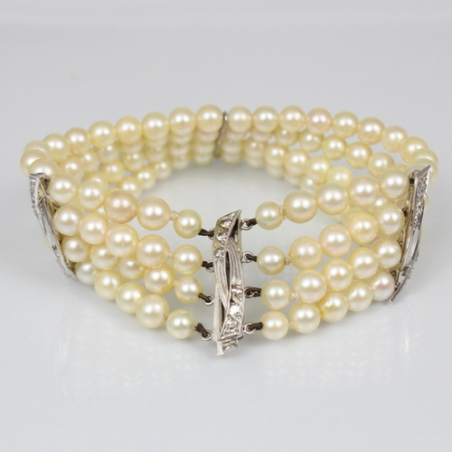 107A - A cultured pearl and diamond bracelet, the three white metal stylised bars set with six graduated di... 