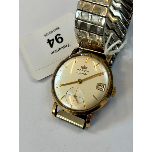 94 - A late 20th century 9ct gold cased 'Marvin Agenda' wristwatch, the circular cream coloured dial with... 